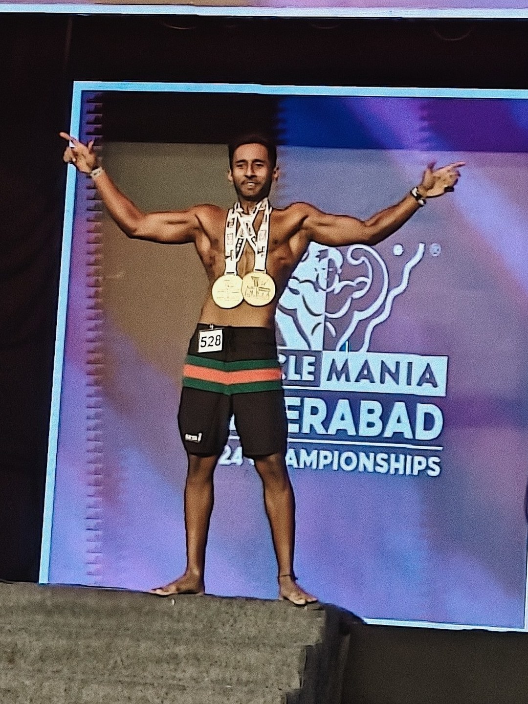 Raj on the podium with two gold medals at the MuscleMania Hyderabad 2024 Championships